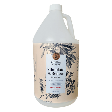 A gallon bottle of Griffin Remedy Stimulate & Renew Shampoo with a label featuring botanical illustrations and text indicating the scent as Peppermint. Natural hair care.