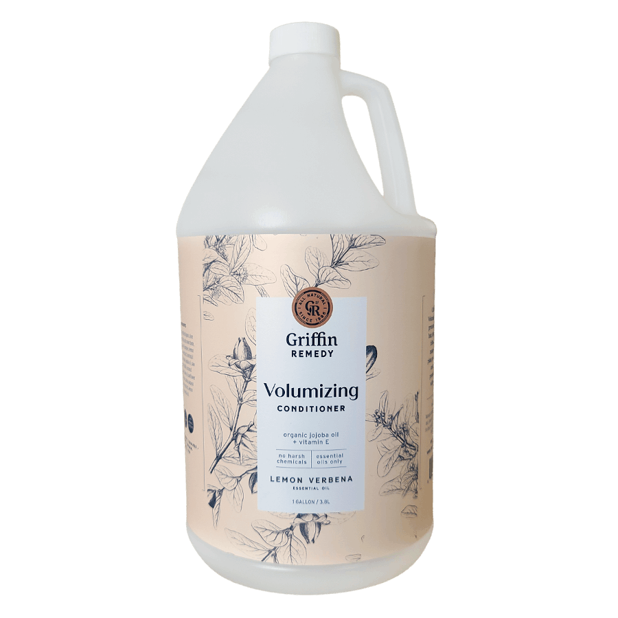 A gallon bottle of Griffin Remedy Volumizing Conditioner with a label featuring botanical illustrations and text. Natural hair care.