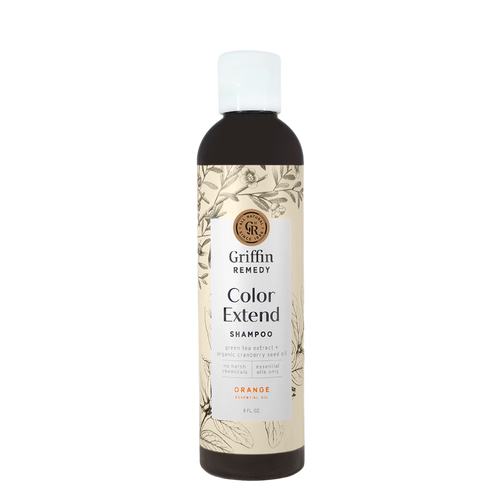 A bottle of Griffin Remedy Color Extend Shampoo with a label featuring botanical illustrations and text indicating the product name and scent. Natural hair care.