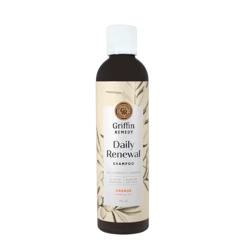 A bottle of Griffin Remedy Daily Renewal Shampoo with a label featuring botanical illustrations and the scent marked as Orange. Natural hair care.