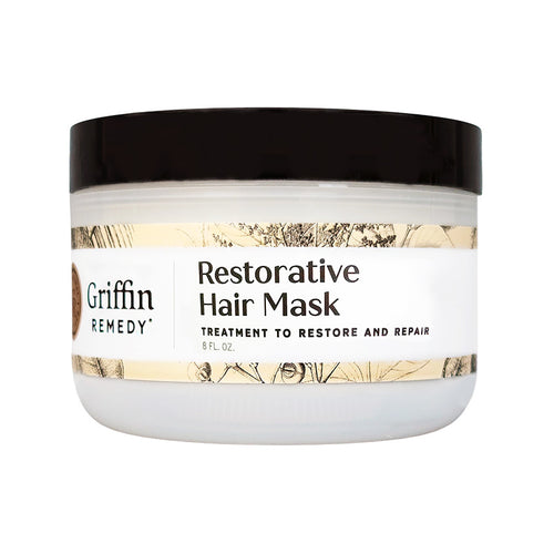 A white jar with a black lid labeled 'Griffin Remedy Restorative Hair Mask' with additional text stating it is a treatment to restore and repair hair. Natural hair care.