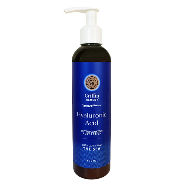 A pump bottle of Griffin Remedy Hyaluronic Acid body lotion with a blue label and dark liquid visible through the bottle. Natural skincare.