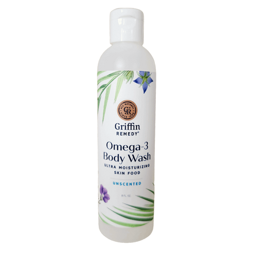 A bottle of Griffin Remedy Omega-3 Creamy Body Wash with a label that includes the product name and 'Unscented' beside it. The bottle is white with green and blue floral design accents. Natural skincare.