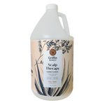 A gallon bottle of Griffin Remedy Scalp Therapy Conditioner with Tea Tree scent, featuring a label with botanical illustrations. Natural hair care.