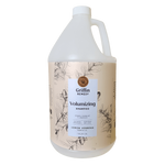 A gallon bottle of Griffin Remedy Volumizing Shampoo with a label featuring botanical illustrations and text indicating the product name and scent, Lemon Verbena. Natural hair care.